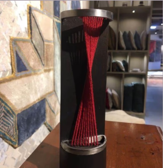 Totem sculpture with red thread detail designed with Studio Pka