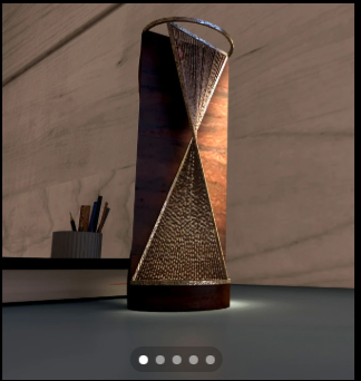 Copper-toned totem sculpture against a stone wall